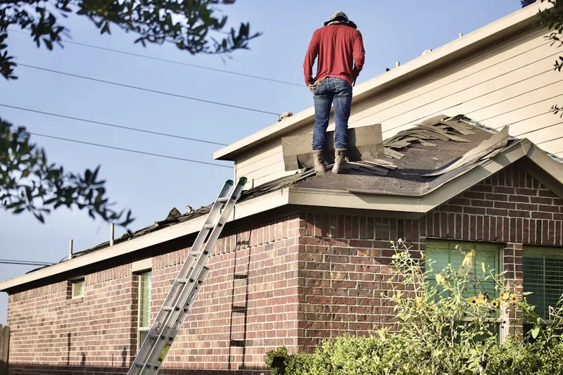 Professional roofer working on a residential roof in Pleasant Hill